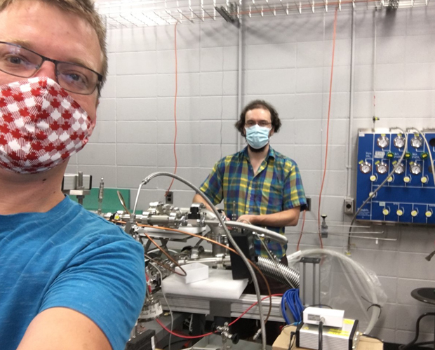 Postdoctoral fellows Alexis Brossard (left) and Jean-François Caron (right) wearing protective masks in the NEWS-G laboratory.