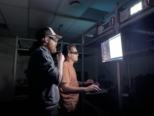 Cedric and Tristan looking at some code