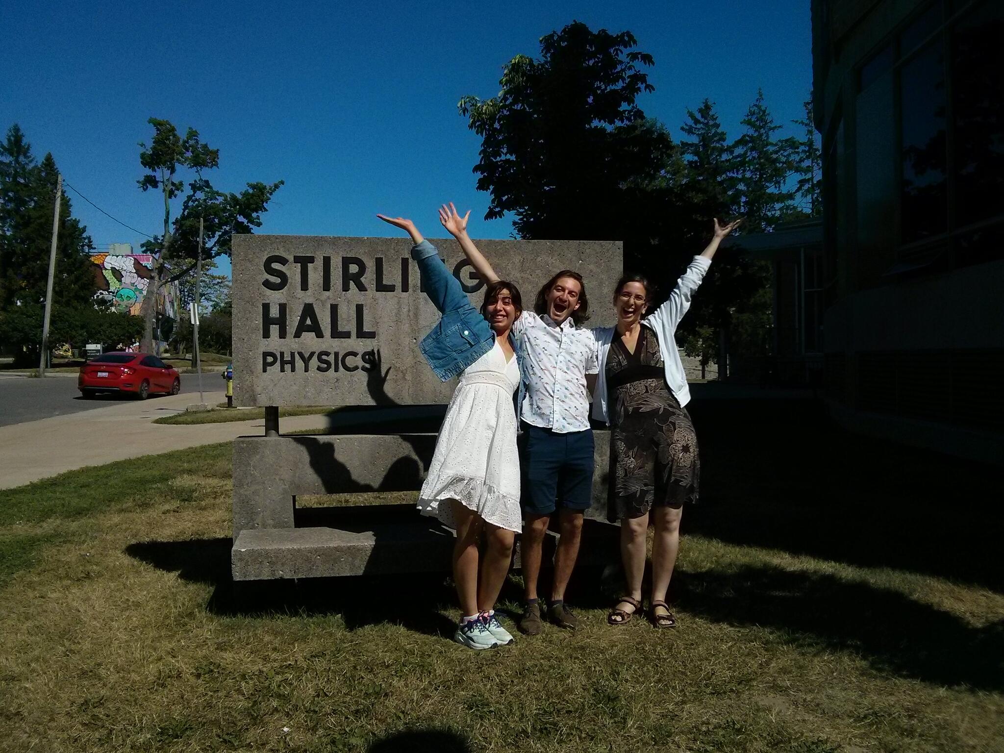 Students Parisa and Arnaud with Prof Sadavoy in front of the Stirling Hall Physics sign
