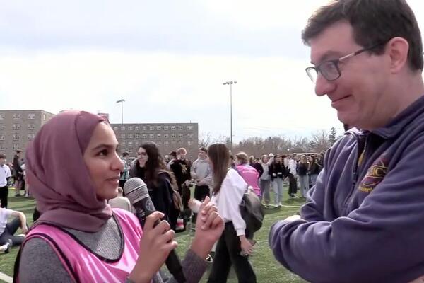 Host Khadeeja Motiwala interviewing Prof. Rob Knobel during the total exclipse on Queen's Campus.