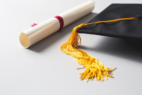 A degree, cap to show successful graduate thesis defense