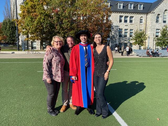 Connor Stone with family and friends at his PhD graduation at near Grant Hall, Queen's University