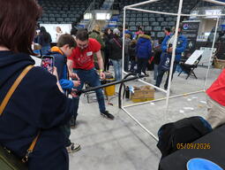 Brian Krar helps a visitor use the vacuum powered ping pong ball cannon.