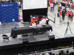 Nik Arora, Minya Bai, and Nick Swidinski making a comet as part of the Physics stage show.