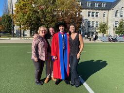 Connor Stone with family and friends at his PhD graduation at near Grant Hall, Queen's University