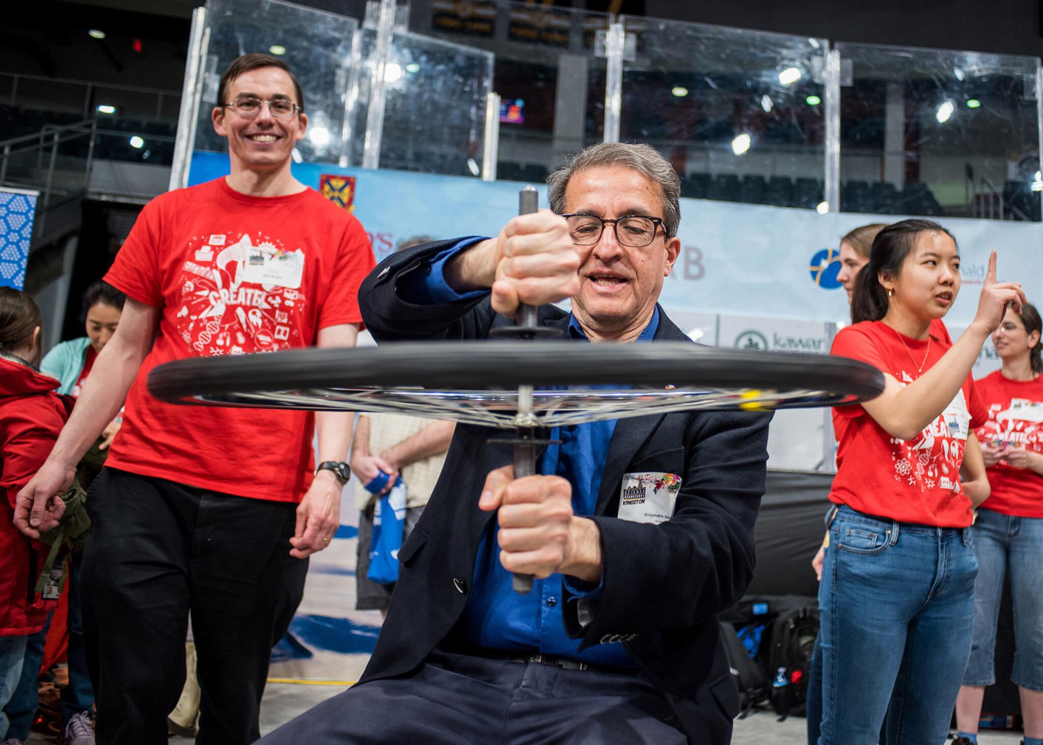 Dr. Alejandro Adem, President of the Natural Sciences and Engineering Research Council of Canada, visited Science Rendezvous Kingston and tried out our angular momentum demonstration.