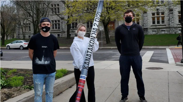 Jeff McCaw, Maranda Cherry and Eric Birchall with their high-powered rocket.