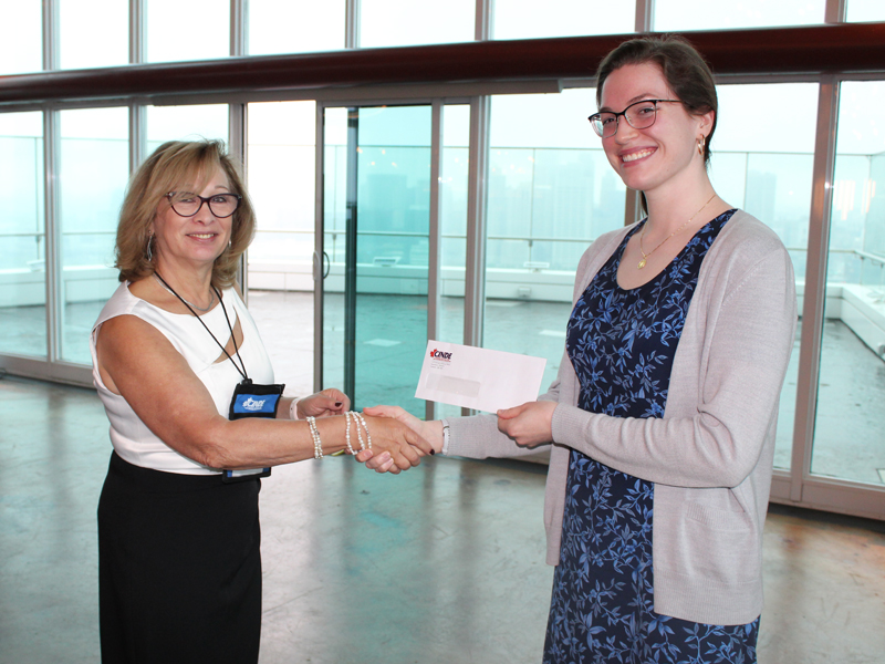 Laura Burchell receiving award for best poster in the poster competition at 2022 NDT Conference
