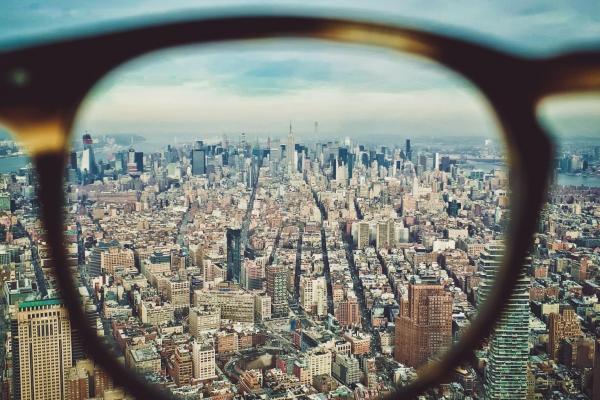 Looking at a city scape through a lens from a pair of glasses