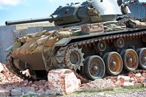 UK tank driving through rubble