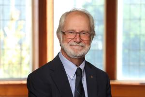 Patrick Deane head and shoulders wearing suit and tie