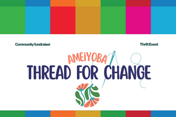 A digital image of "Ameiyoba Thread For Change" written on a white background with a blue sewing needle behind the text, and the thread connecting to the stem of a flower.