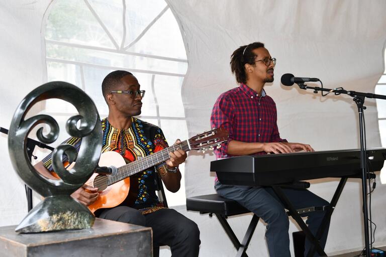 person playing guitar and person singing