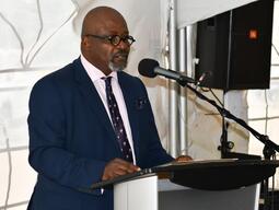 person speaking at lectern