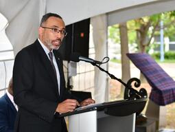 Mr. Edward Thomas at a lectern