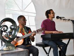 person playing guitar and person singing