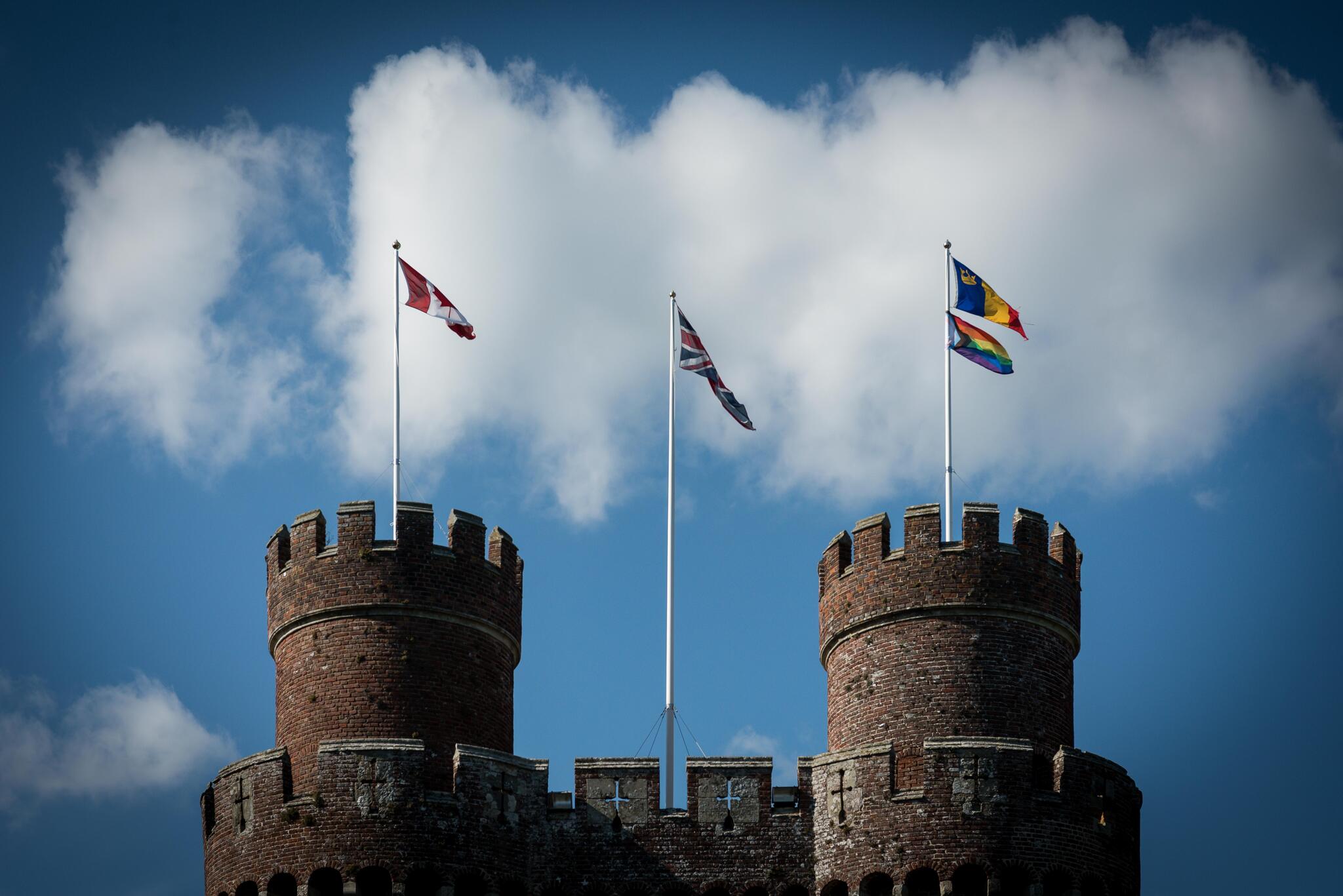 Canadian, UK, and Queen's Pride flag on top of a castle