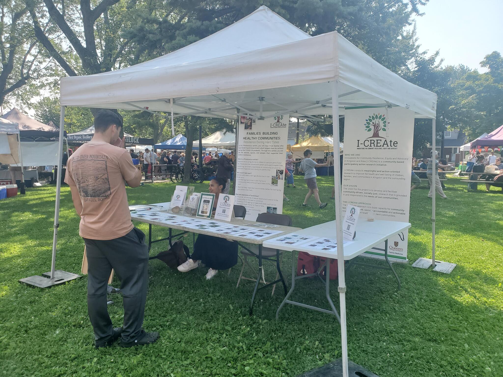 A man standing in front of an info booth outside
