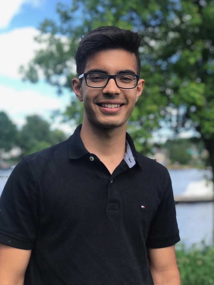 young man smiling outside