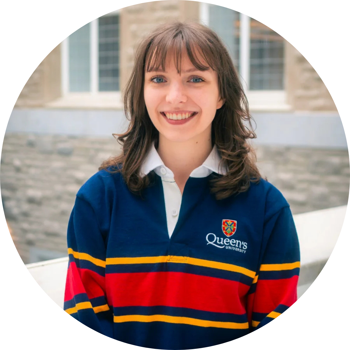 Woman with shoulder length brown hair wearing Queen's rugby shirt