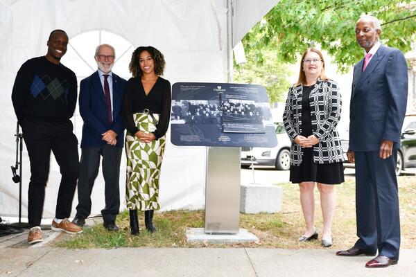 From left: Mudia Iyayi (MD student), Patrick Deane (Principal and Vice-Chancellor), Raquel Oleksin (MD student), Jane Philpott (Dean, Queen's Health Sciences), and Lanval Daly (the second Black medical student admitted to Queen's following the ban) standing with the new plinth.