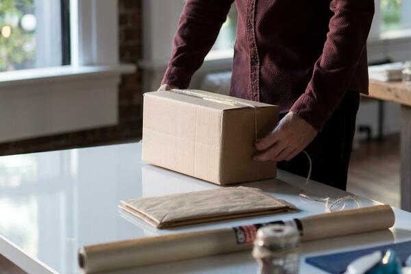 Person wrapping up a small parcel