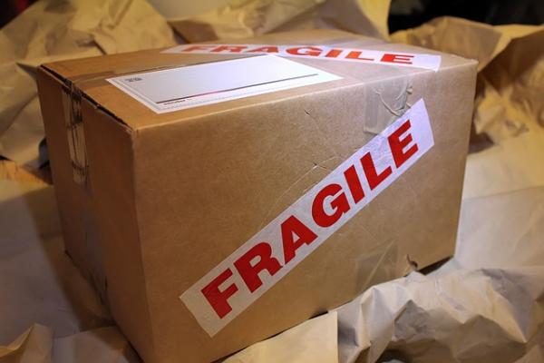 Cardboard box with fragile tape on it