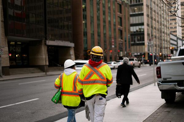 Construction workers wearing high visibility vests