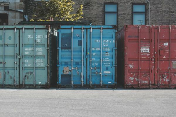 Three c-can shipping containers lined up in a row