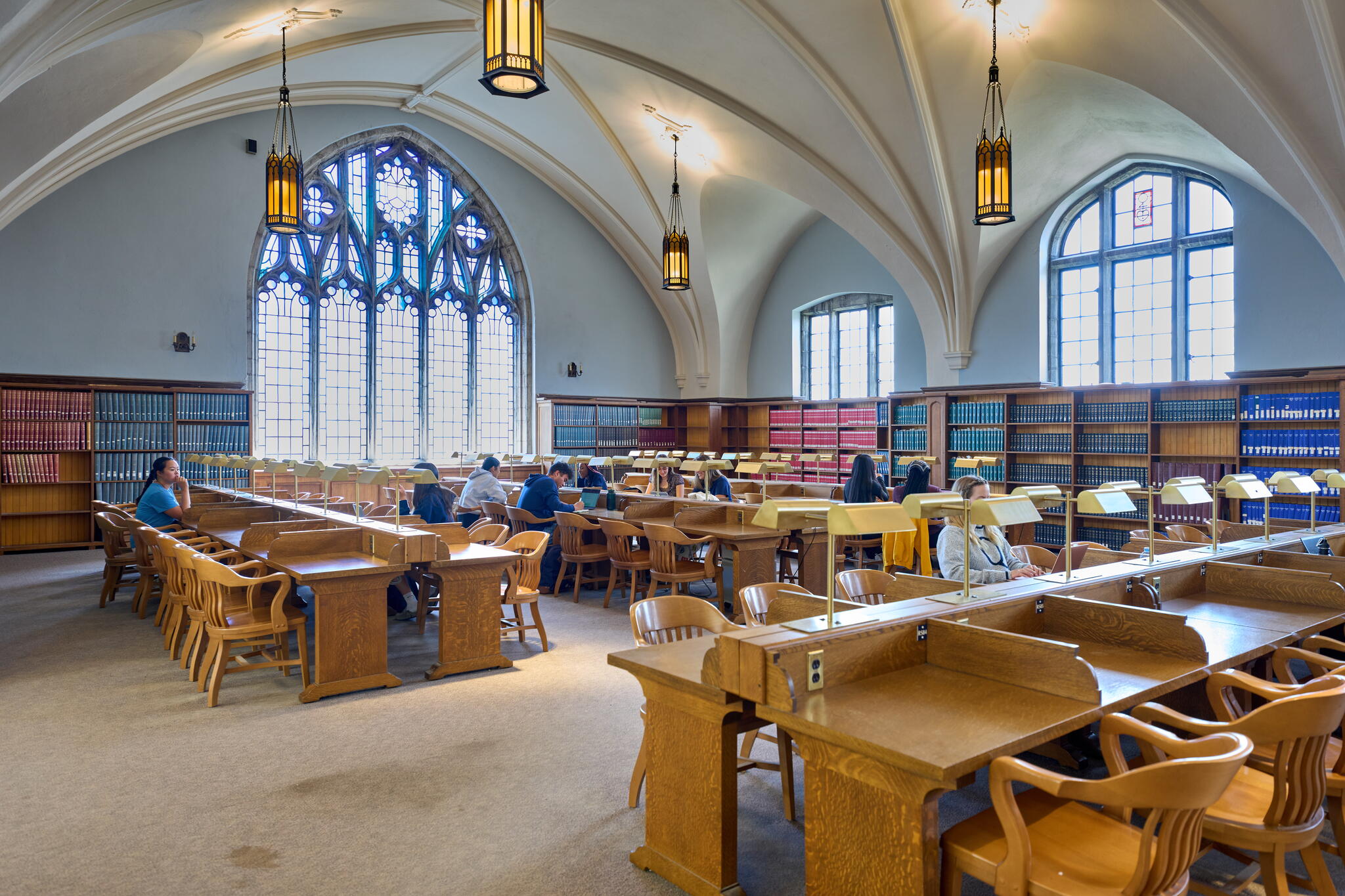 Interior of the Douglas Library with desks and stain glass windows