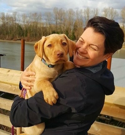 Julie headshot with a puppy