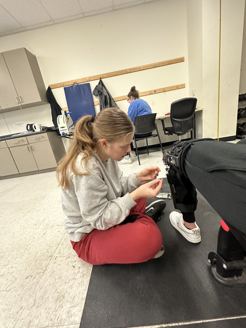 Kristine instrumenting a leg brace. November 2023