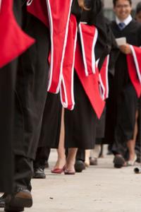 Photo of people carrying graduation gowns, proceeding towards convocation