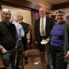 Multiple groups of people talking in a room