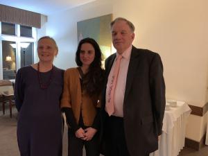 Three people standing in front of a table