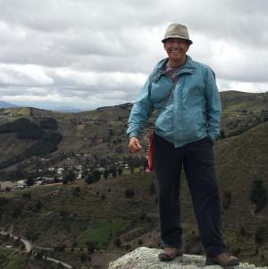 A person standing overlooking hills