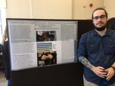 A person standing to the right of a poster