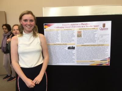 A person standing in front of a poster