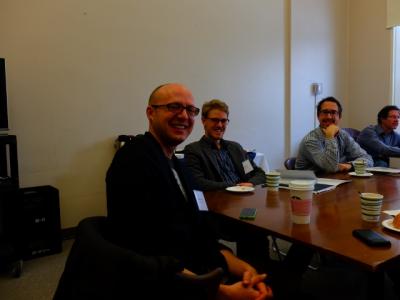 Three people seated at a table having a conversation