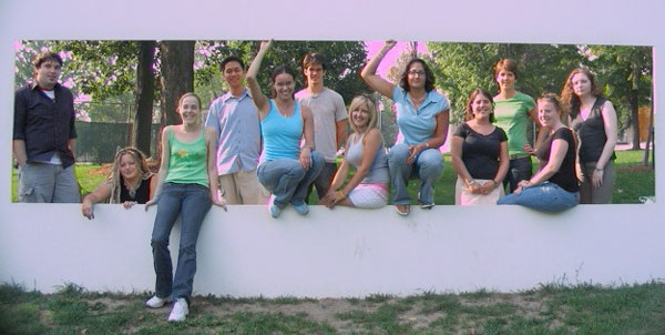 12 Students sitting on a wall