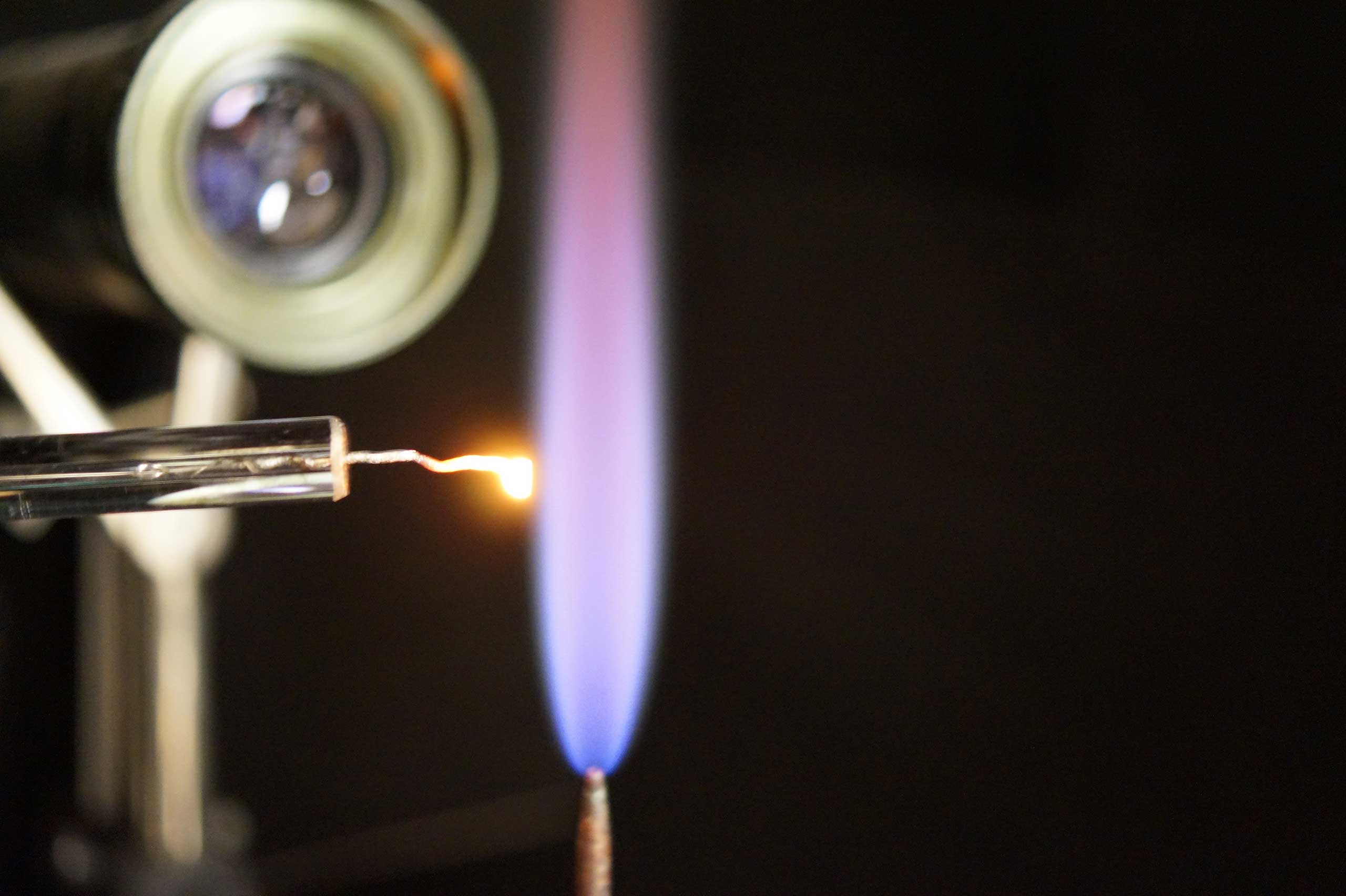 A platinum single crystal being annealed using a hydrogen flame
