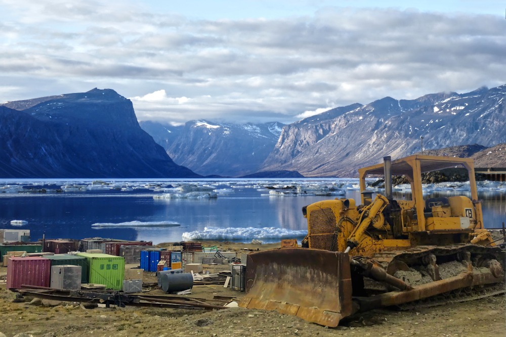 [Photo of the water with industrial equipment on the bank in Inuit Nunangat by micky renders]
