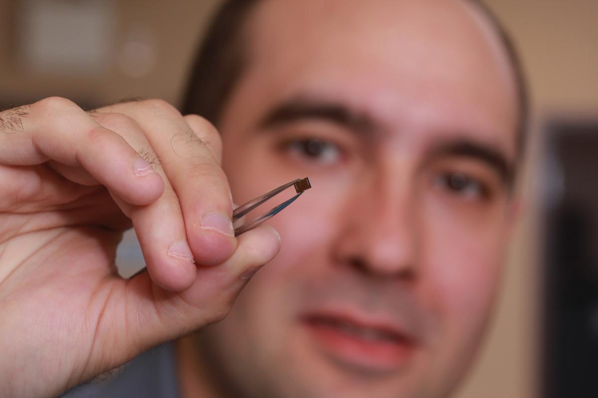 [photo of Marko Krstic holding a microchip]