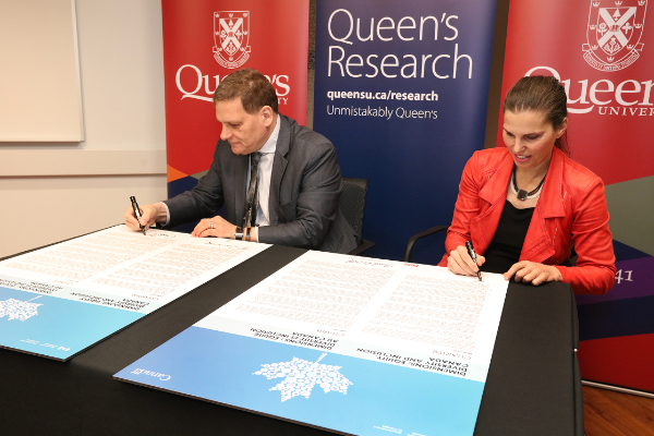 Queen's Principal and Vice-Chancellor, Daniel Woolf, and Minister of Science and Sport, Kirsty Duncan, sign the Dimensions EDI charter.