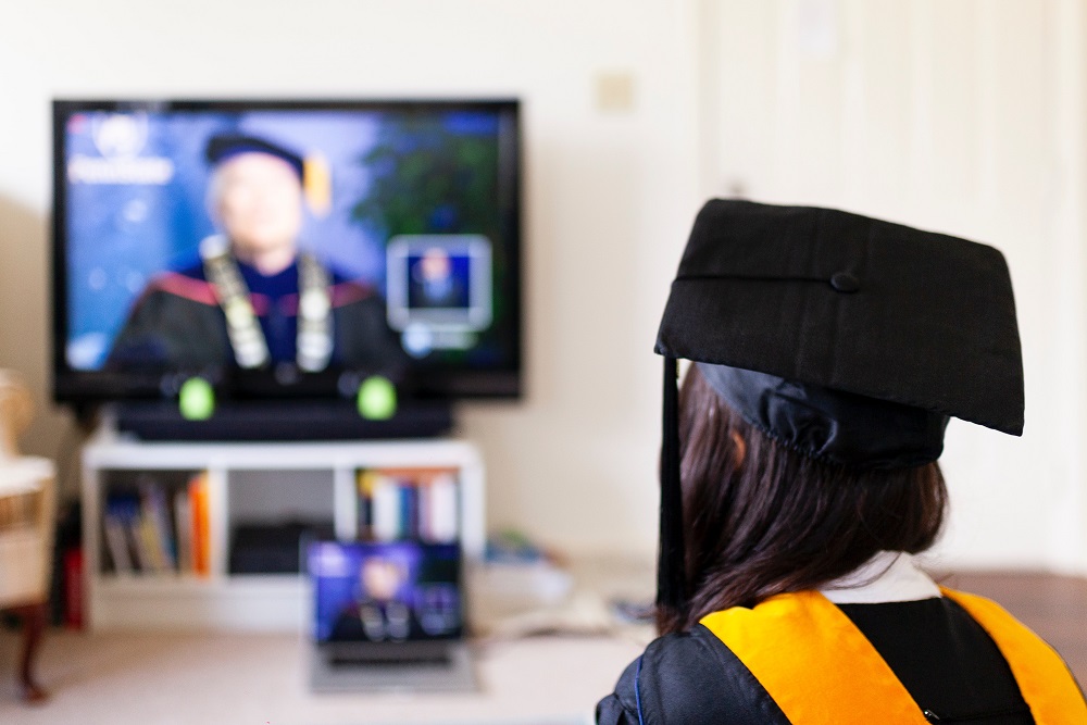 [Photo of a graduate attending their convocation ceremony virtually]