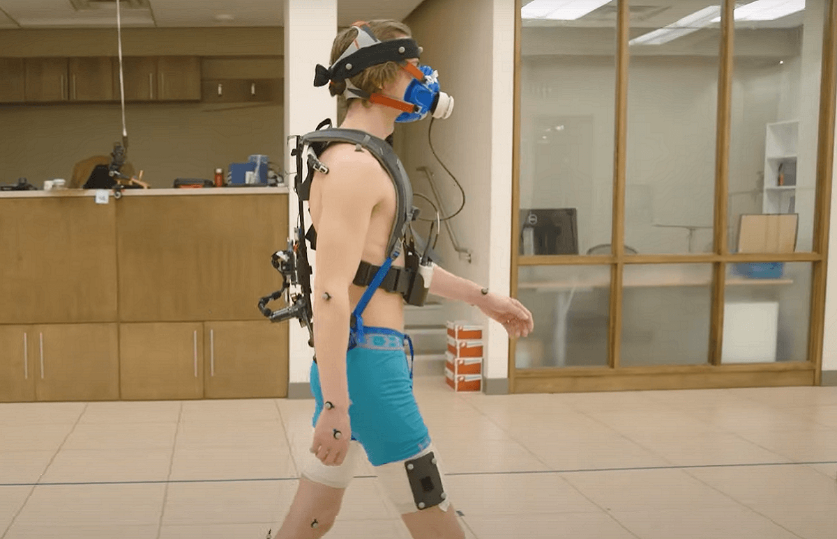 [Photo of a researcher testing the exoskeleton design]