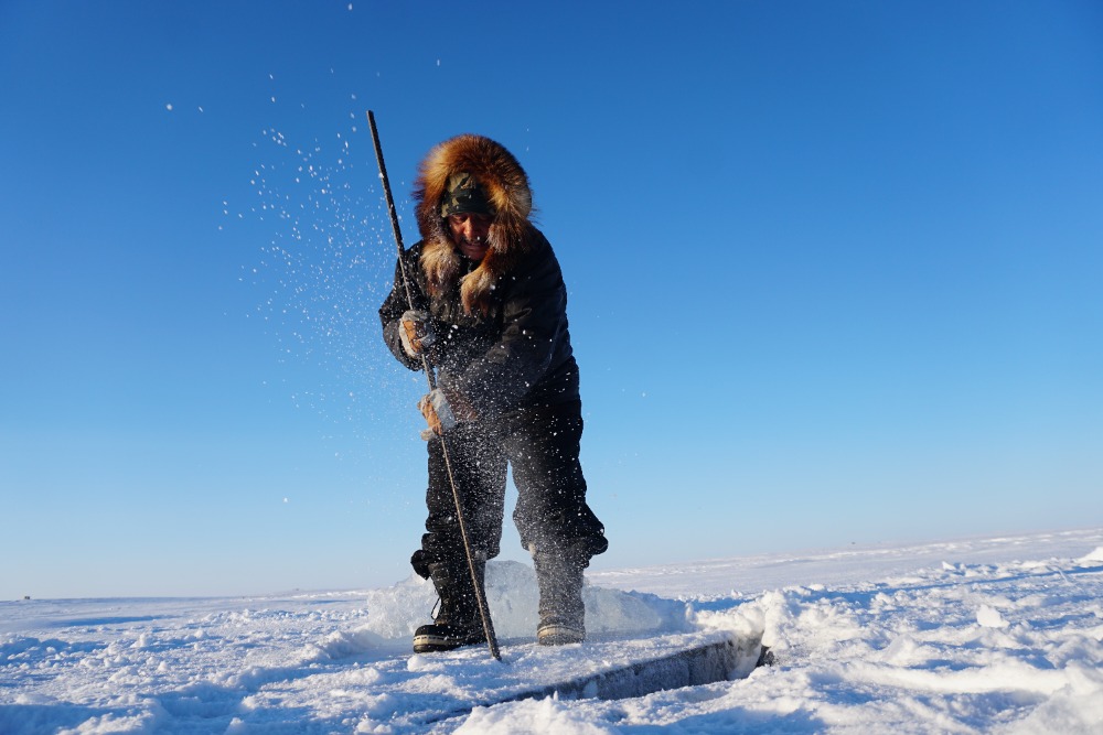 [Photo of George Konana collecting ice photographer by Saskia de Wildt]