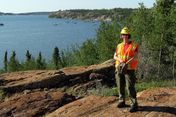 Dr. Heather Jamieson samples soil near the Giant Mine in Yellowknife]