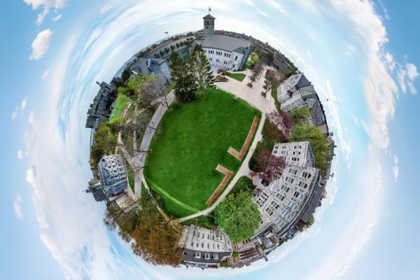 [Illustrative aerial drone photo of Queen's campus]