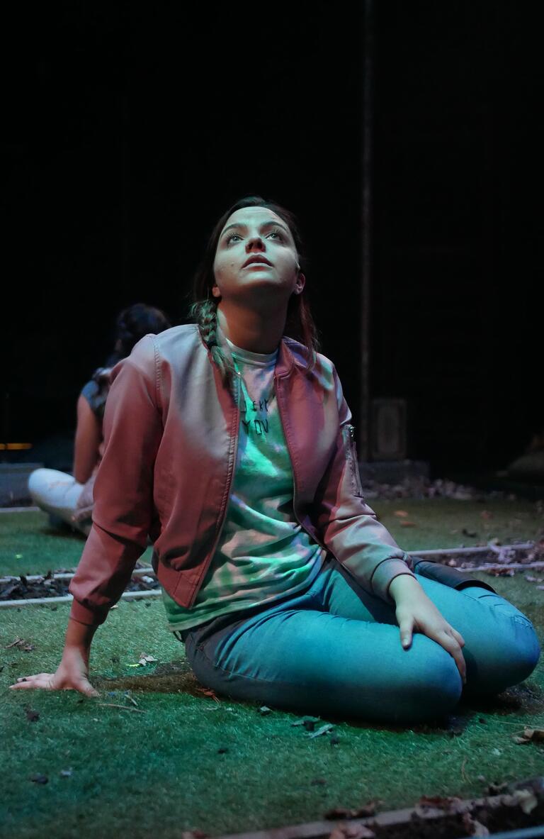 Woman sitting on the ground looking up